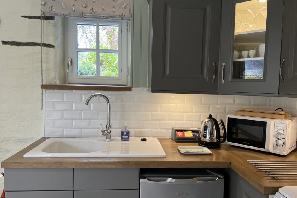 Fully equipped kitchen in Hayloft Gîte at Kergudon, Brittany self-catering accommodation.