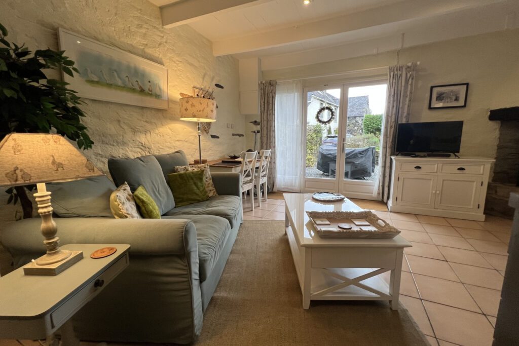 Studio living area in Hayloft Gîte at Kergudon, Brittany self-catering cottage with cosy seating and natural light.
