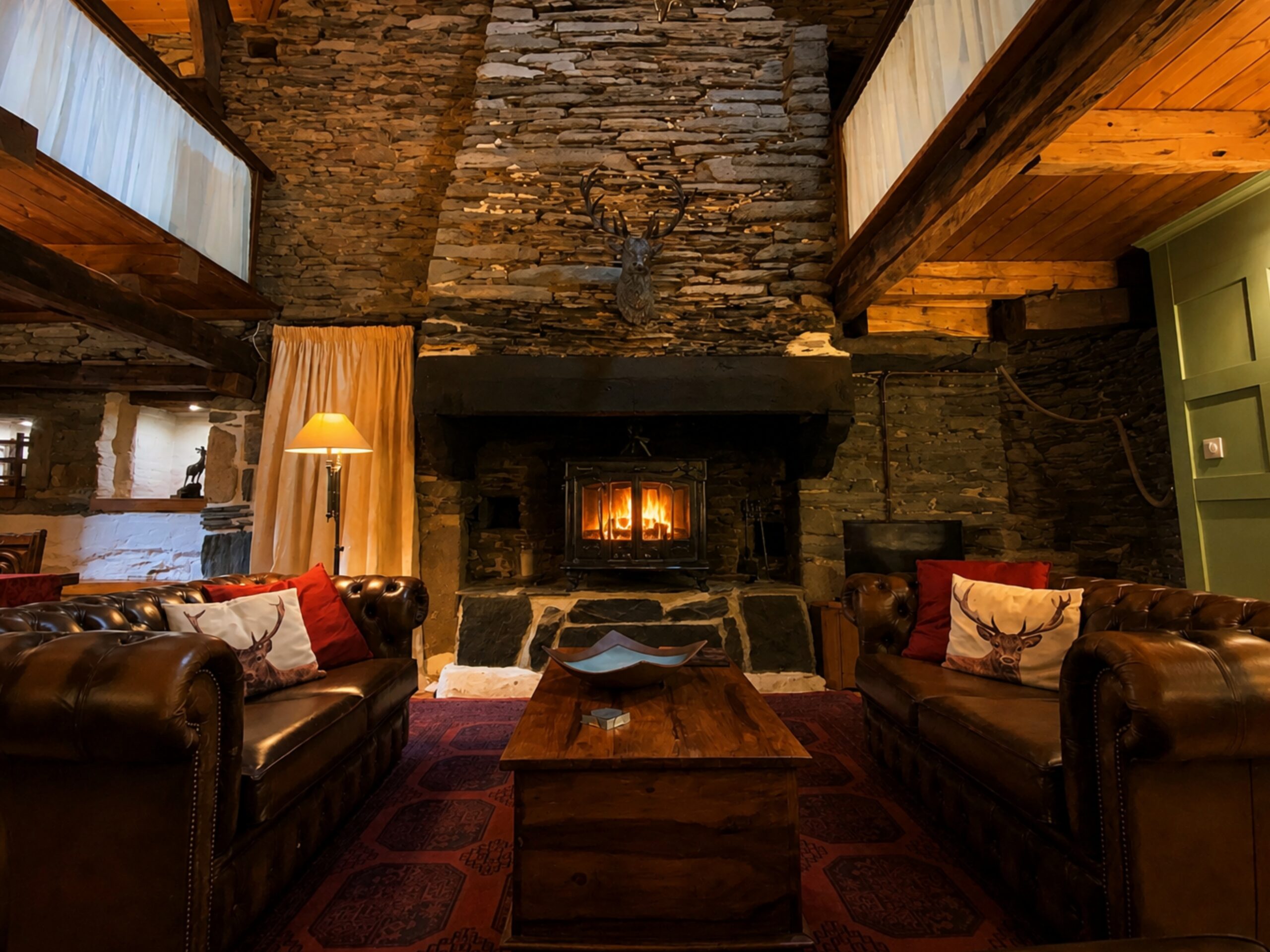 A cosy living room with a wood-burning stove inside a traditional holiday cottage at Kergudon in Brittany during winter