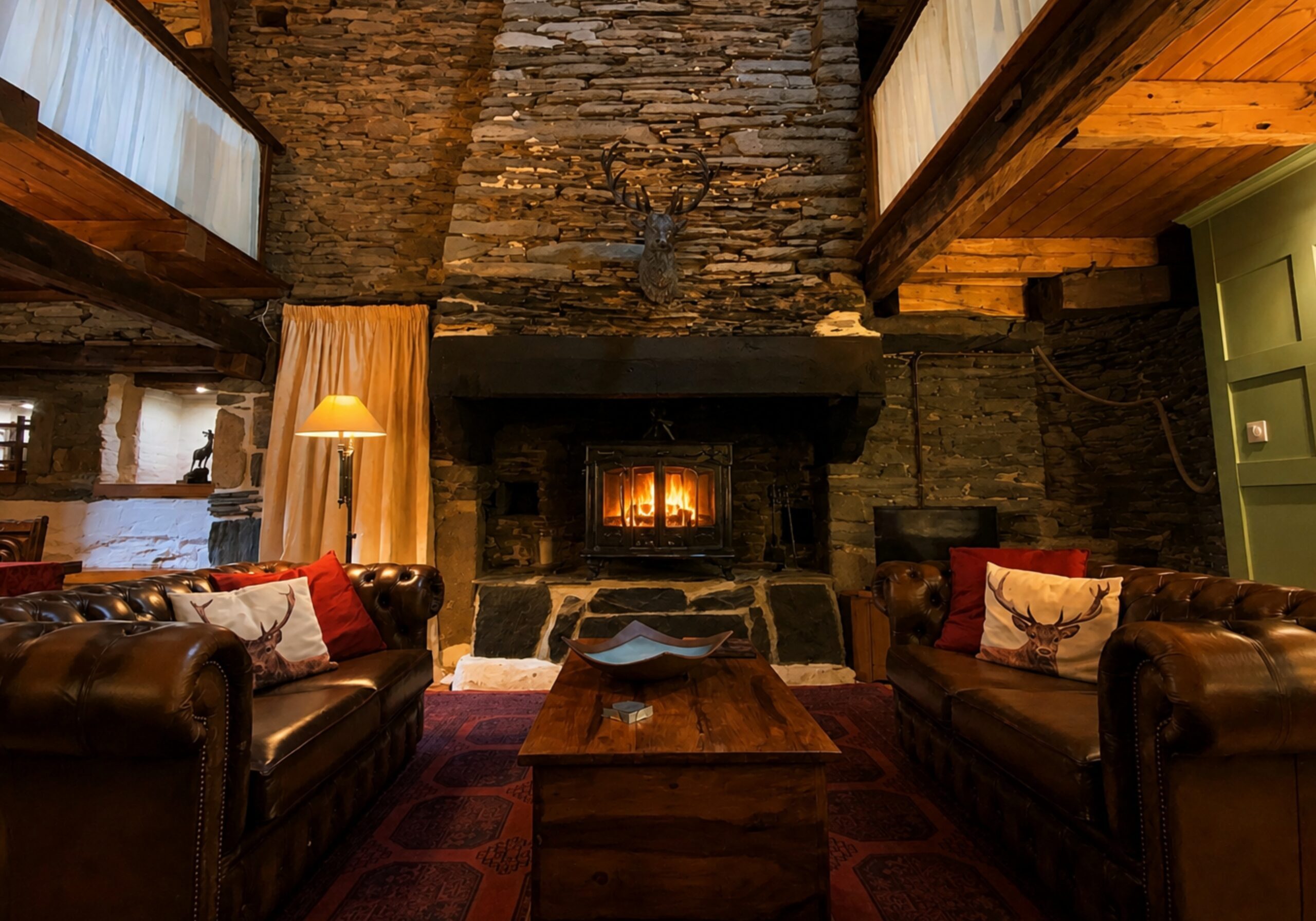 A cosy living room with a wood-burning stove inside a traditional holiday cottage at Kergudon in Brittany during winter