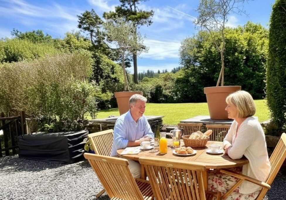 Couple enjoying breakfast outside at Kergudon in Brittany
